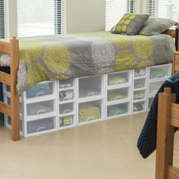 Clear plastic drawers under a dorm bed